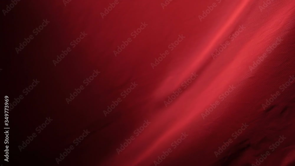 The chic and elegant texture of the moving folds of light red fabric on a black background under dramatic lighting. Slow Motion 200 FPS
