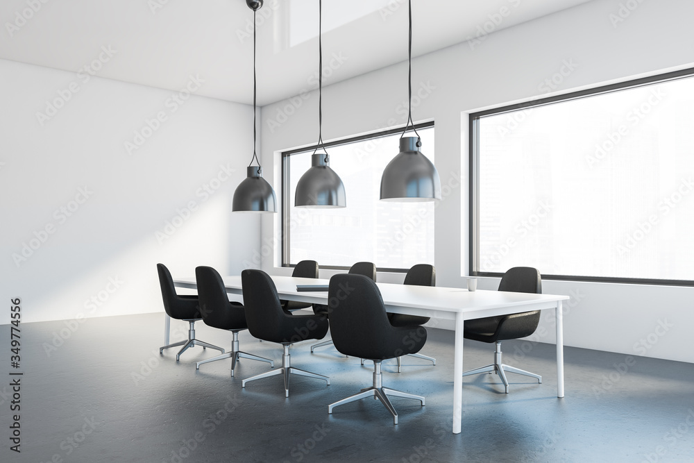 White meeting room corner with black chairs