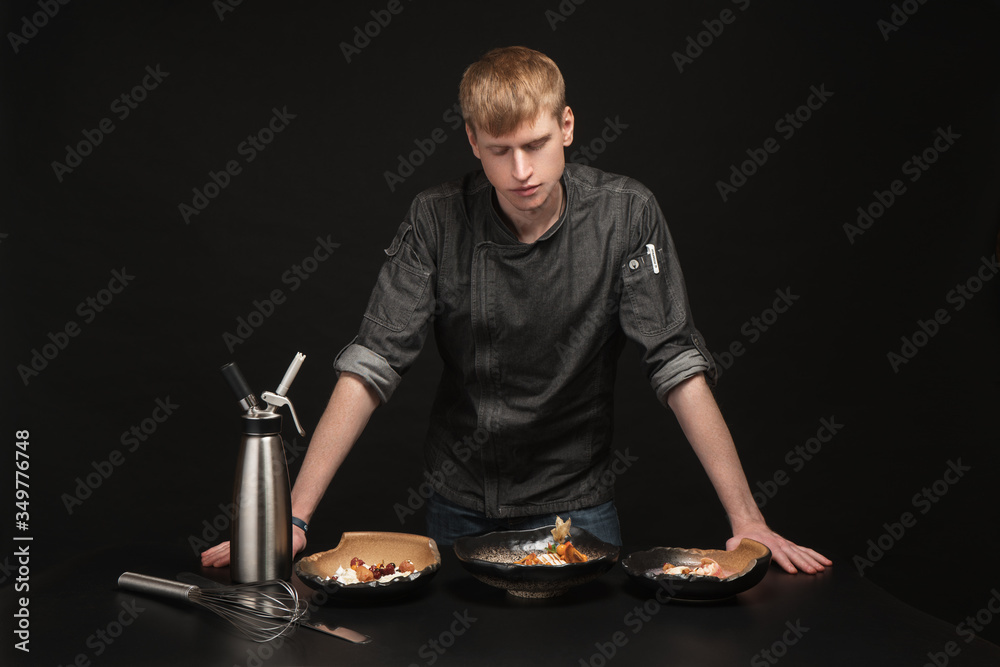 Baking process. Portrait of a male chef cook Baking process. Portrait of a male chef cook