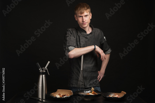 Baking process. Portrait of a male chef cook