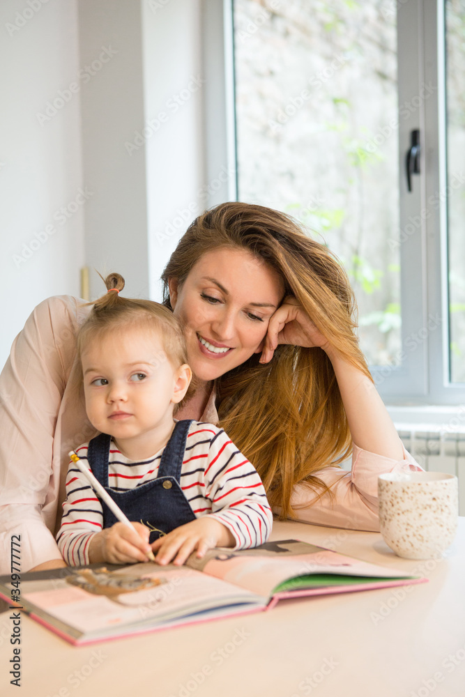 Mother mother reading book to her toddler