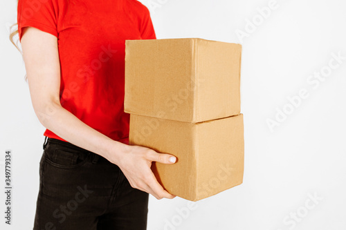 The courier holds cardboard boxes on an isolated white background. Fast and free delivery. Online stores and Express delivery © Shopping King Louie