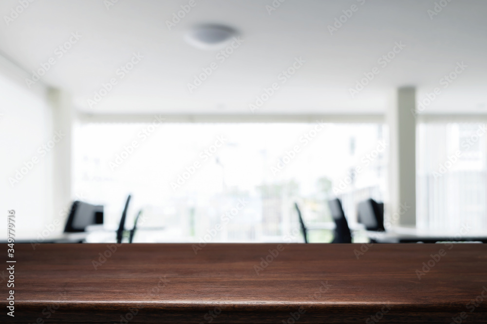 Empty wooden desk space over blurred office or meeting room background. Product display. Empty wooden desk space over blurred office or meeting room background. Product display.