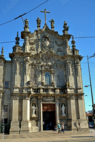 Porto, Portugal - August 18, 2015: Beautiful facade of the twin churches Igreja do Carmo and Igreja dos Carmelitas. On the side is a panel of azulejos inaugurated in 1922. photo