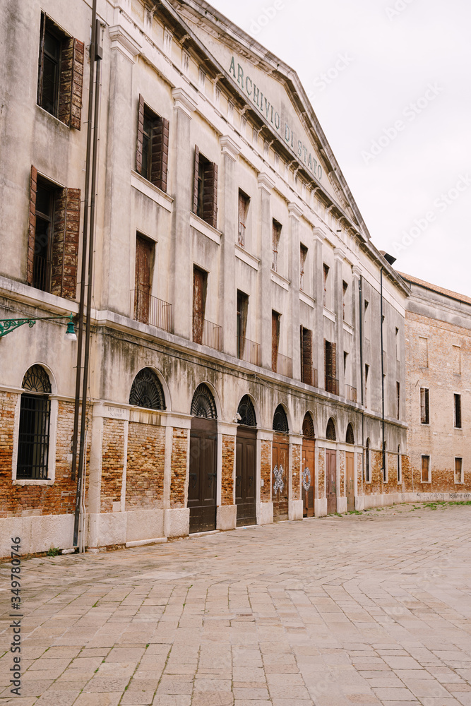 A deserted street of Venice, Italy. Facade of the building of the State Archive of Venice - Archivio di Stato di Venezia.