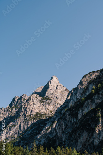 Dolomites - a mountain range in the Eastern Alps, in the Southern Limestone Alps system. The array is located in the north-eastern part of Italy. Bright sunny October day, cloudy blue sky.