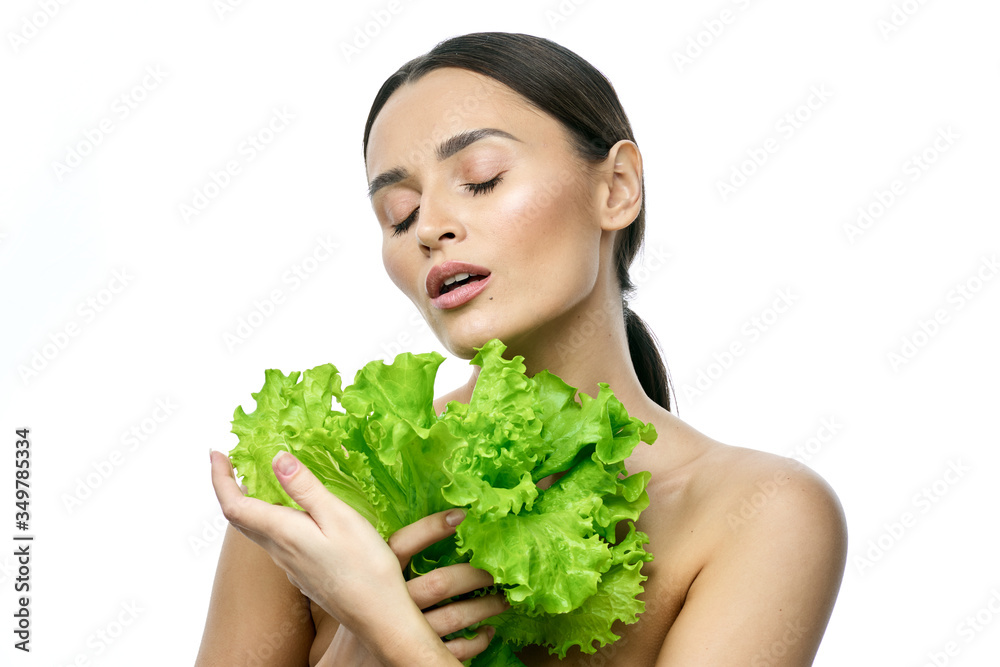 portrait of a girl with clean skin without makeup with a leaf of green salad portrait of a girl with clean skin without makeup with a leaf of green salad