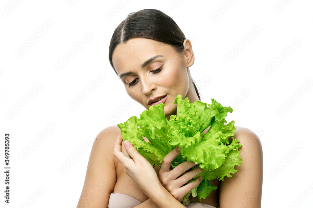 portrait of a girl with clean skin without makeup with a leaf of green salad portrait of a girl with clean skin without makeup with a leaf of green salad