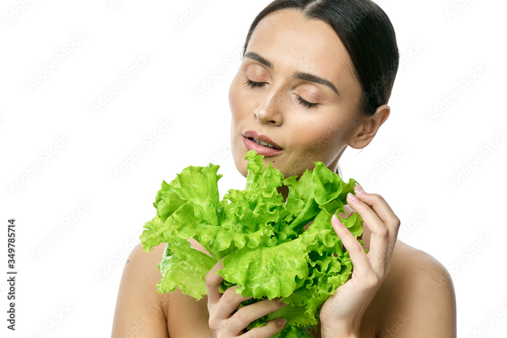 portrait of a girl with clean skin without makeup with a leaf of green salad portrait of a girl with clean skin without makeup with a leaf of green salad