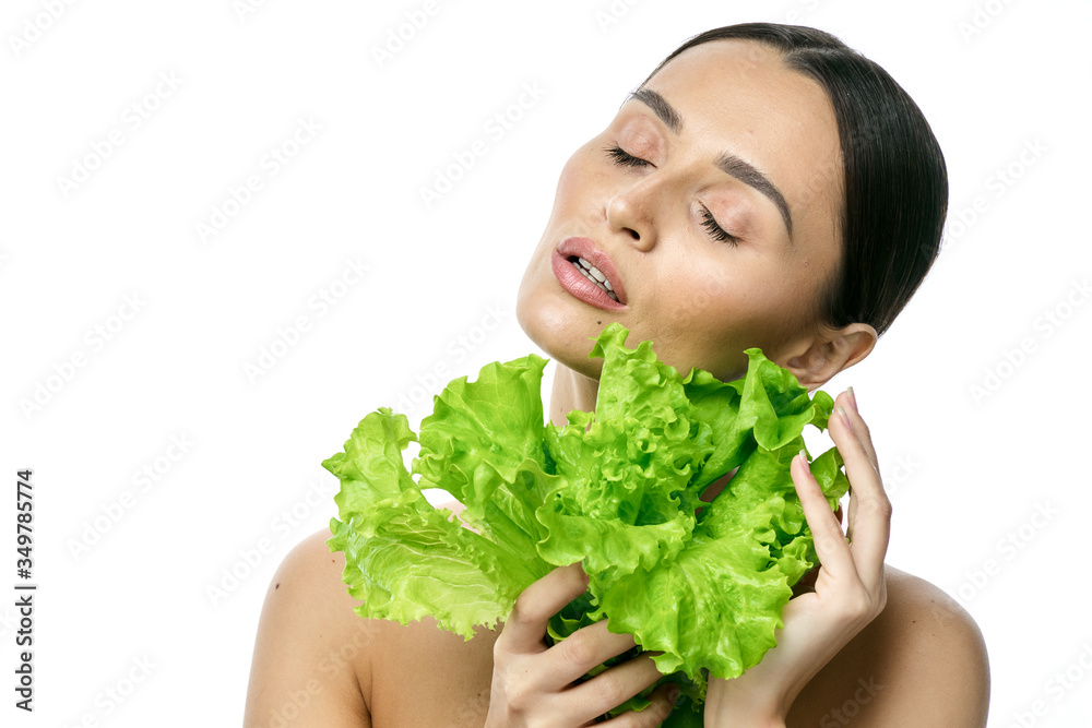 portrait of a girl with clean skin without makeup with a leaf of green salad portrait of a girl with clean skin without makeup with a leaf of green salad