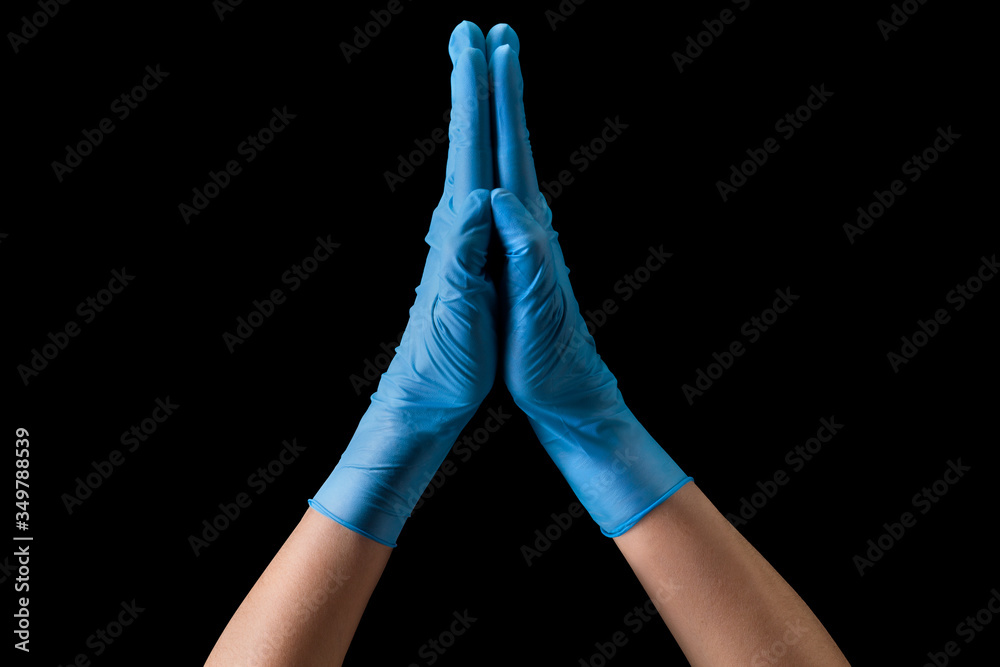 Fototapeta premium Doctor's hand in sterile medical gloves together symbolizing prayer isolated