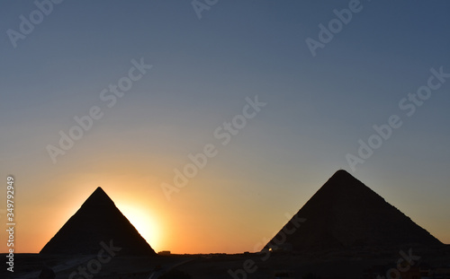 beauty sunset background of pyramids giza CAIRO EGYPT.Silhouette pyramids when sunset and orange sky