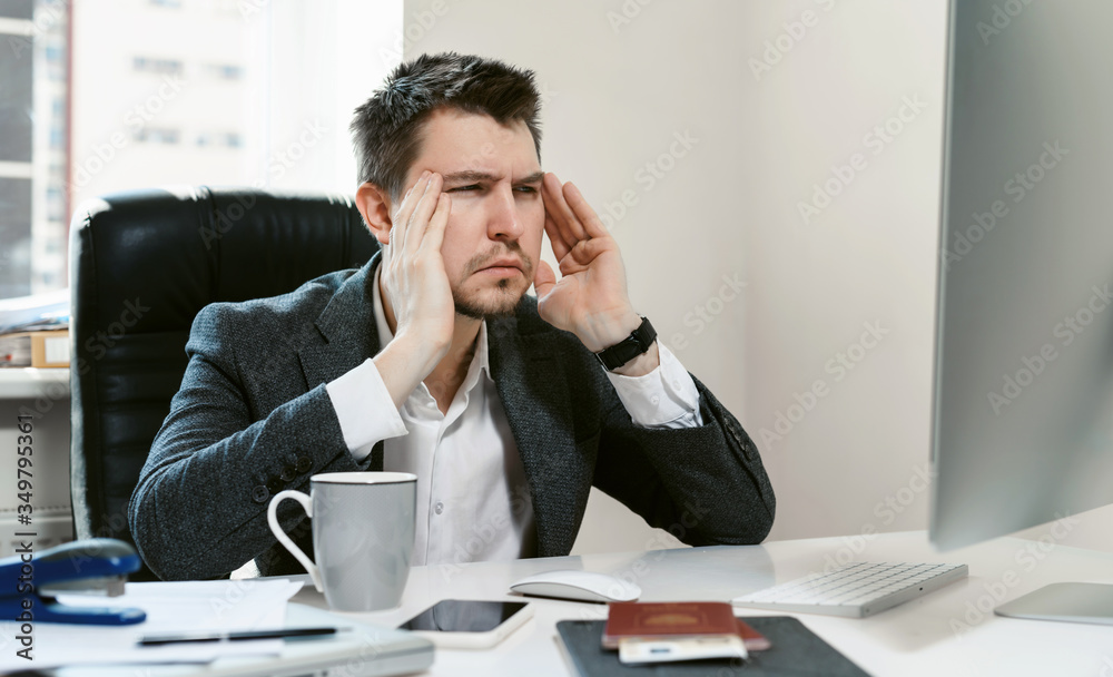 Headache from crisis. Businessman is tired of problems, shocked and holding his head. The collapse of the oil market. The fall of the stock market. Economic crisis. Sales Manager, financial broker. Headache from crisis. Businessman is tired of problems, shocked and holding his head. The collapse of the oil market. The fall of the stock market. Economic crisis. Sales Manager, financial broker.