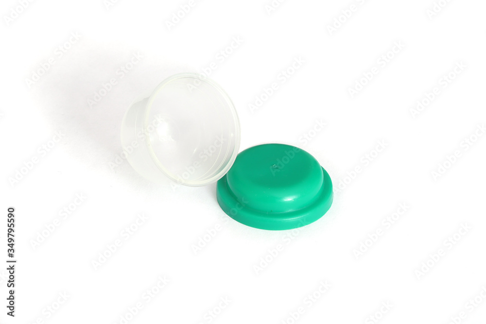 Container. Spherical open container with a green lid. Isolate of a small plastic container. Container. Spherical open container with a green lid. Isolate of a small plastic container.