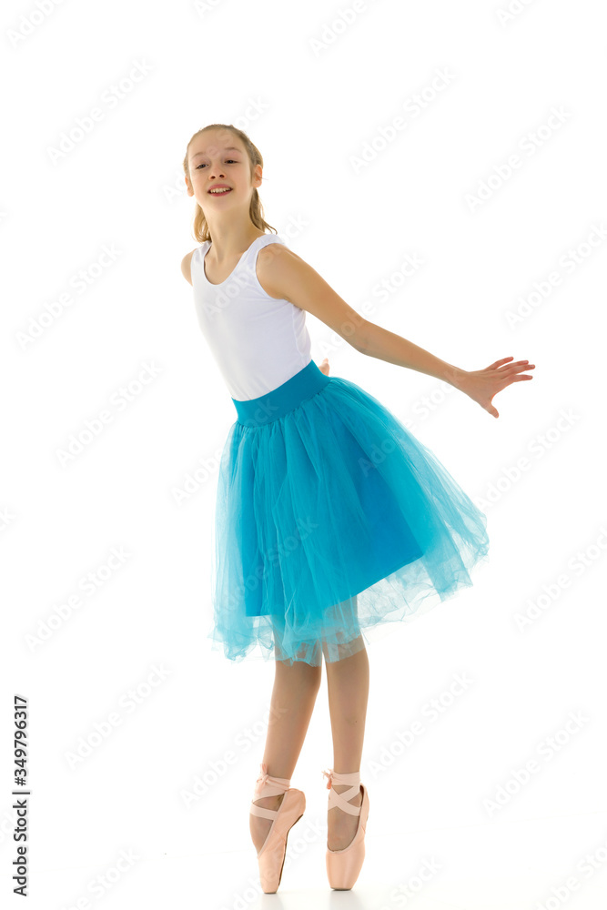Cute little girl in a tutu and pointe shoes dancing in the studio. Cute little girl in a tutu and pointe shoes dancing in the studio.