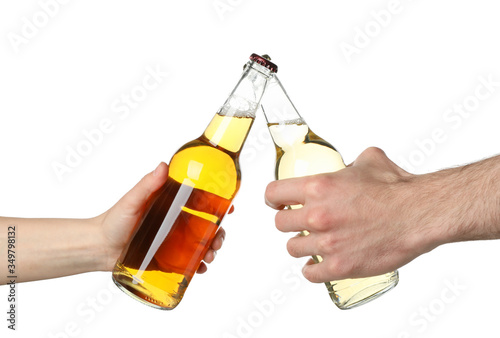 Hands hold bottles of cider, isolated on white background. Cheers