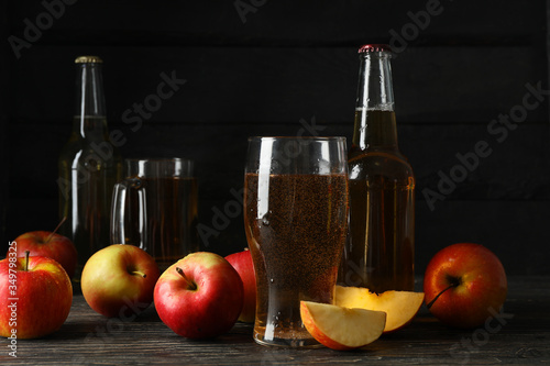 Composition with cider and apples on wooden background