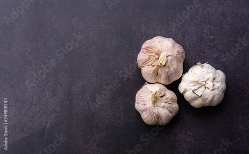 Fresh Garlic on black wall background, top view