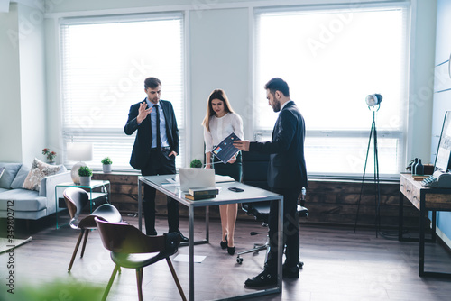 Group of modern colleagues in office clothes