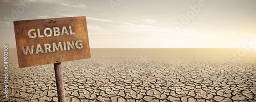 Εκτύπωση καμβά Rusty sign with text Global warming on a background of dry cracked desert