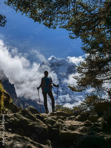 Active hiker in travel to Everest enjoying the view of Thamserku mount in Himalaya mountains landscape