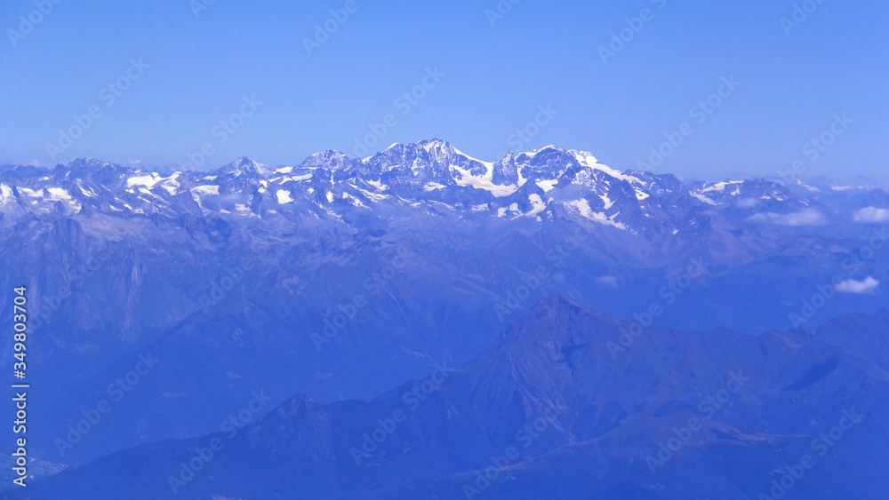 The view from the airplane window on a picturesque mountains landscape The view from the airplane window on a picturesque mountains landscape