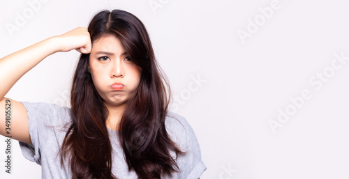 Young asian woman is stupid, dumb and silly. She always forget things every time, isolated on white, copy space. Pretty asian woman get boring. Pretty girl gesture on face like a upset, unhappy, bored