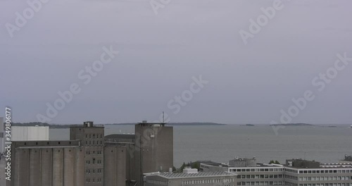 4K Helsinki Baltic Sea Finnish Bay lagoon, buildings and port construction cranes cloudy summer day video in Jatkasaari district in Finland capital, northern Europe photo