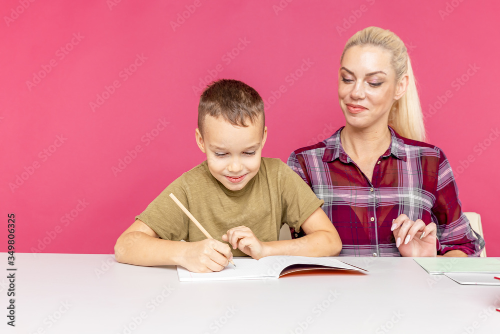 Tutor with child doing homework together at home Tutor with child doing homework together at home