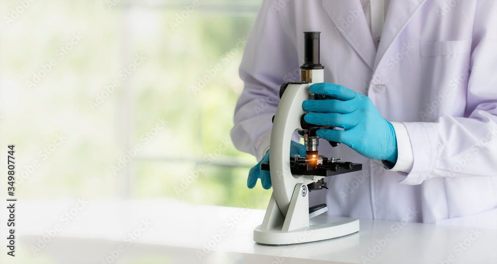 laboratory concept; Scientist uses a microscope in the laboratory laboratory concept; Scientist uses a microscope in the laboratory