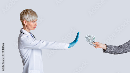 Bribe concept. Strict doctor dont takes money of patient