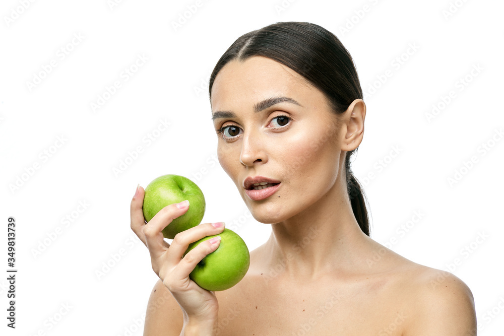close-up portrait of a girl with clear skin holding a apple to her face, isolated on a white background close-up portrait of a girl with clear skin holding a apple to her face, isolated on a white background