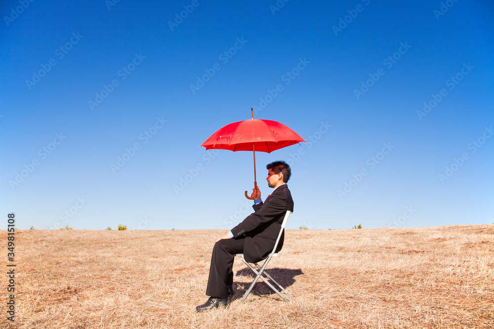 .Businessman with a red umbrella .Businessman with a red umbrella