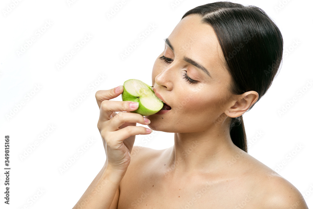 close-up portrait of a girl with clear skin holding a apple to her face, isolated on a white background close-up portrait of a girl with clear skin holding a apple to her face, isolated on a white background