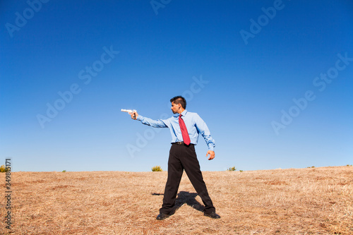 Businessman aiming a handgun