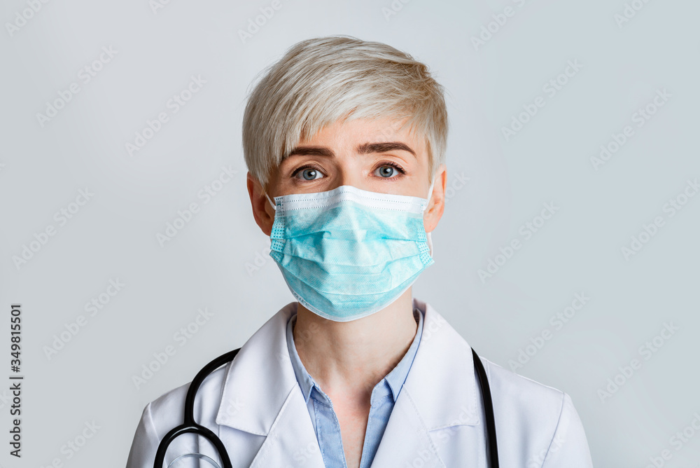 Health and medicine concept. Portrait of friendly therapist in protective mask, close up Health and medicine concept. Portrait of friendly therapist in protective mask, close up