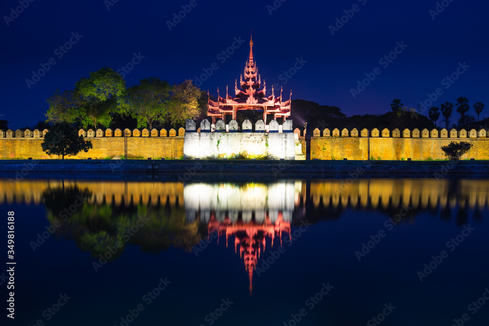 Mandalay palace wall at night with reflection in Mandalay city, Myanmar