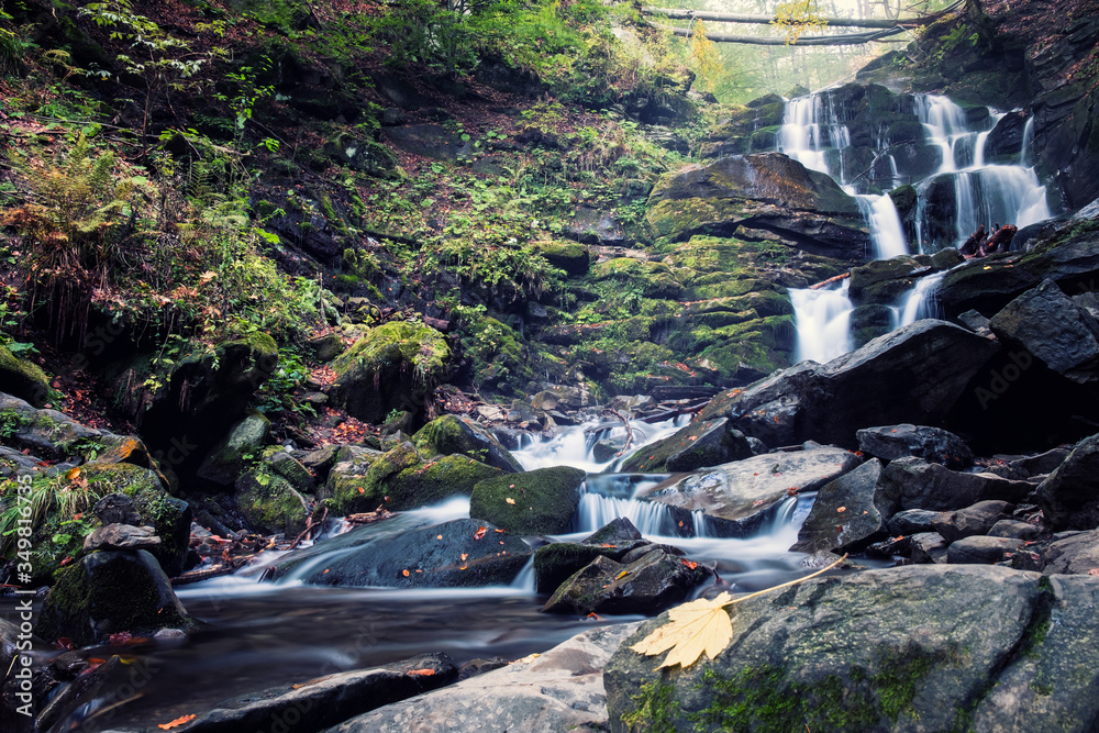 Fototapeta premium waterfall in deep forest. Cascad creek in mountains
