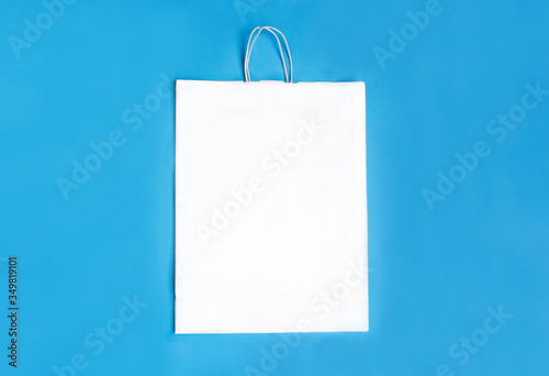 White paper package in the centre on a blue background. Space for text