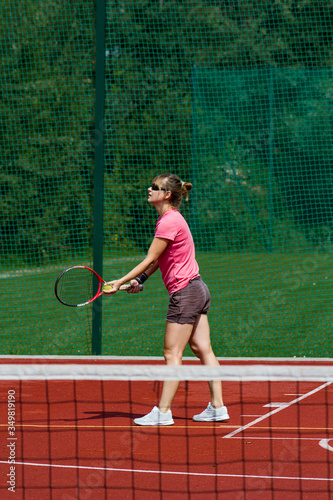 Female tennis player prepares to serve © ffolas