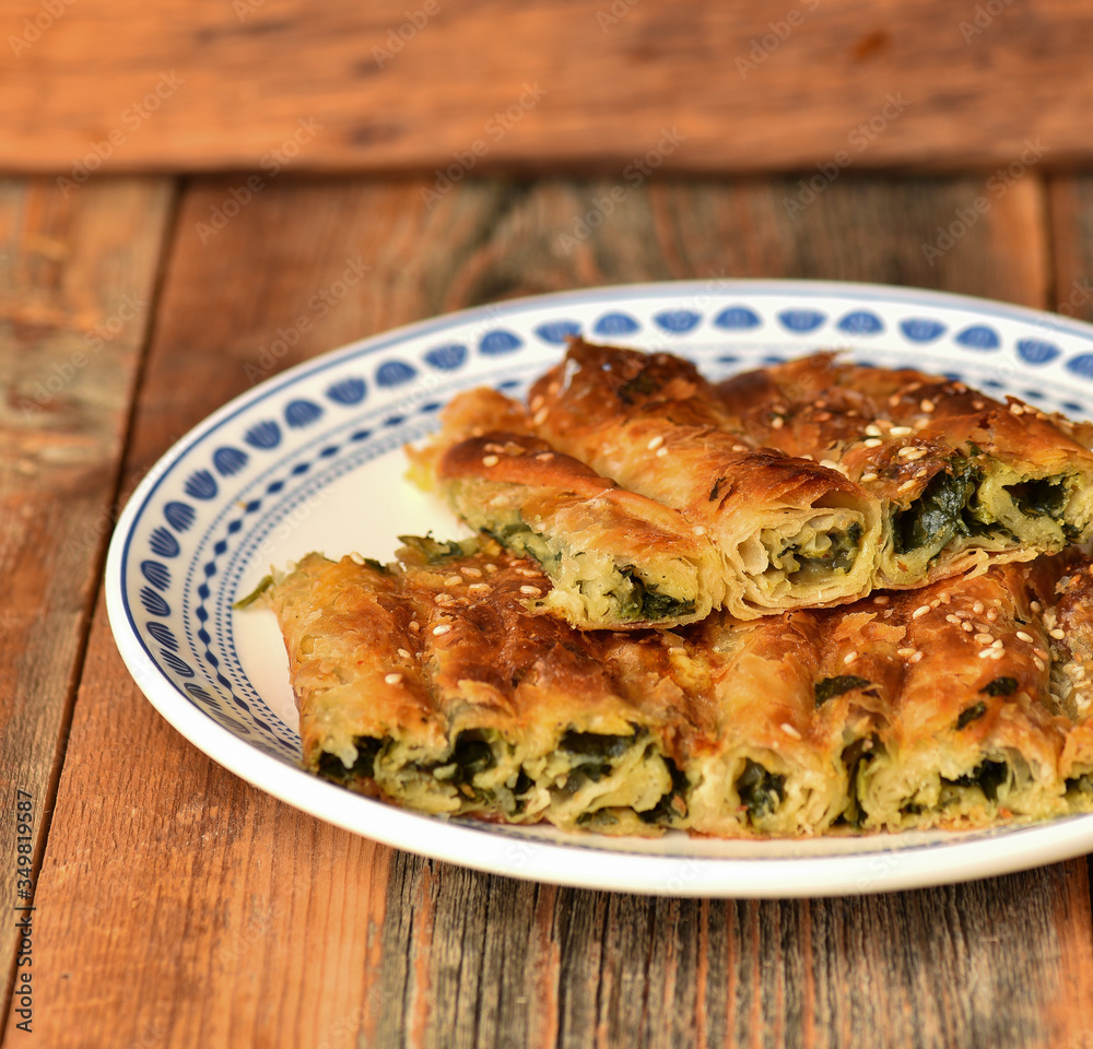 Traditional Turkish pastry with spinach. (Turkish Name: Ispanakli Kol Boregi). Handmade pastry with spinach filling. Traditional Turkish pastry with spinach. (Turkish Name: Ispanakli Kol Boregi). Handmade pastry with spinach filling.