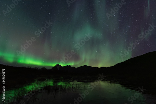 Northern lights over the mountain, Lofoten islands, Norway © surachetkhamsuk
