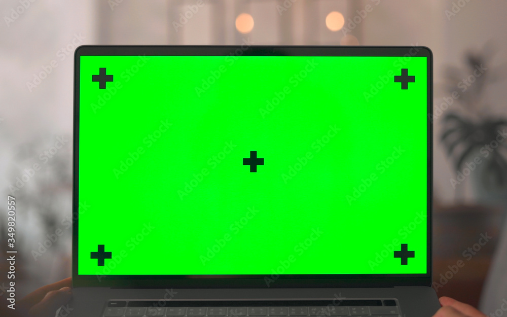 Green Screen Mock Up in hands person lying on sofa in room 