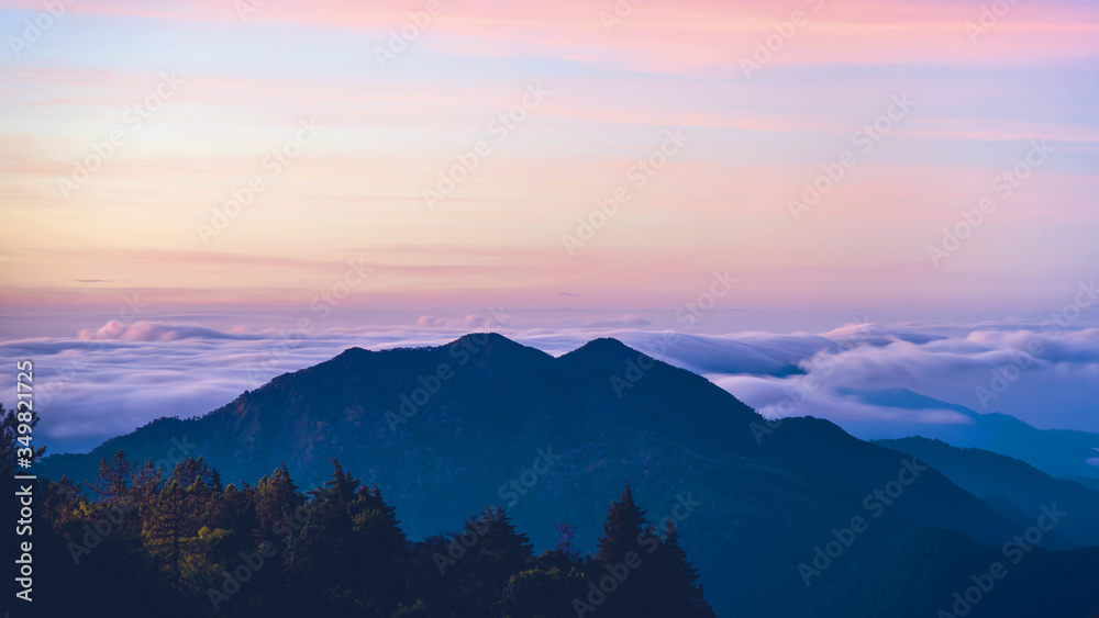 Mountain fog valley during sunrise.The background of nature with fog on the mountain, In the rainy weather in the countryside