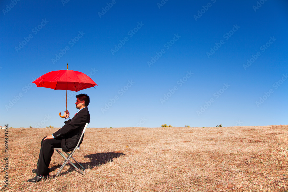 Businessman with a red umbrella Businessman with a red umbrella