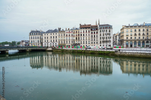 The city of Bayonne in France with buildings in the Nive River