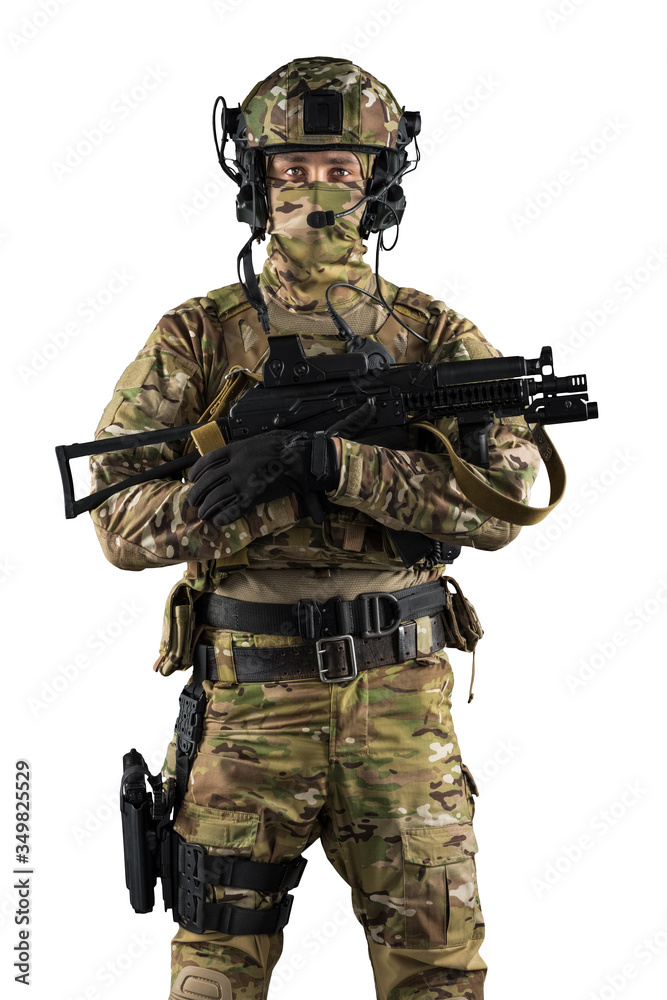 Soldier holding assault rifle. Uniform conforms to special services of the Russian Federation. Shot in studio. Isolated with clipping path on white background