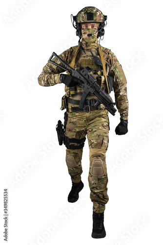 Soldier holding assault rifle. Uniform conforms to special services of the Russian Federation. Shot in studio. Isolated with clipping path on white background © maximapryatin