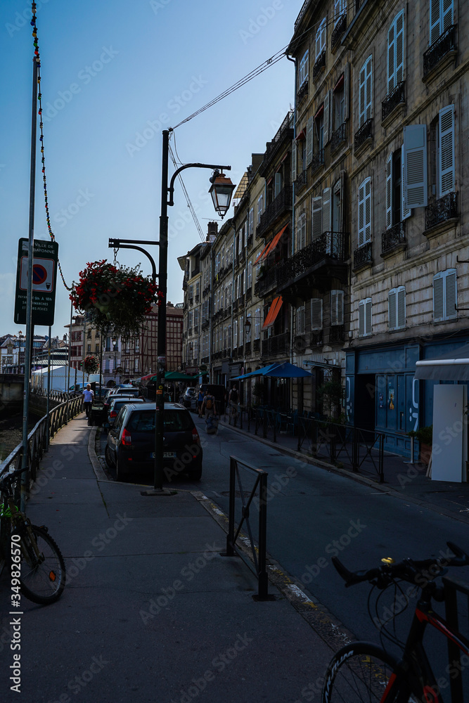 Street of Bayonne in France with buildings in the Nive River