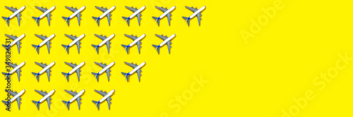Pattern made of model airplane on yellow background. Travel vacation summer concept. Top view, flat lay. Airlines out of service concept. Out of business airliners. Corona virus pandemic.